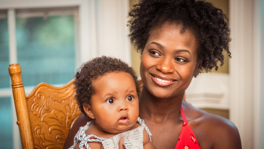 A caregiver holding and talking with a baby