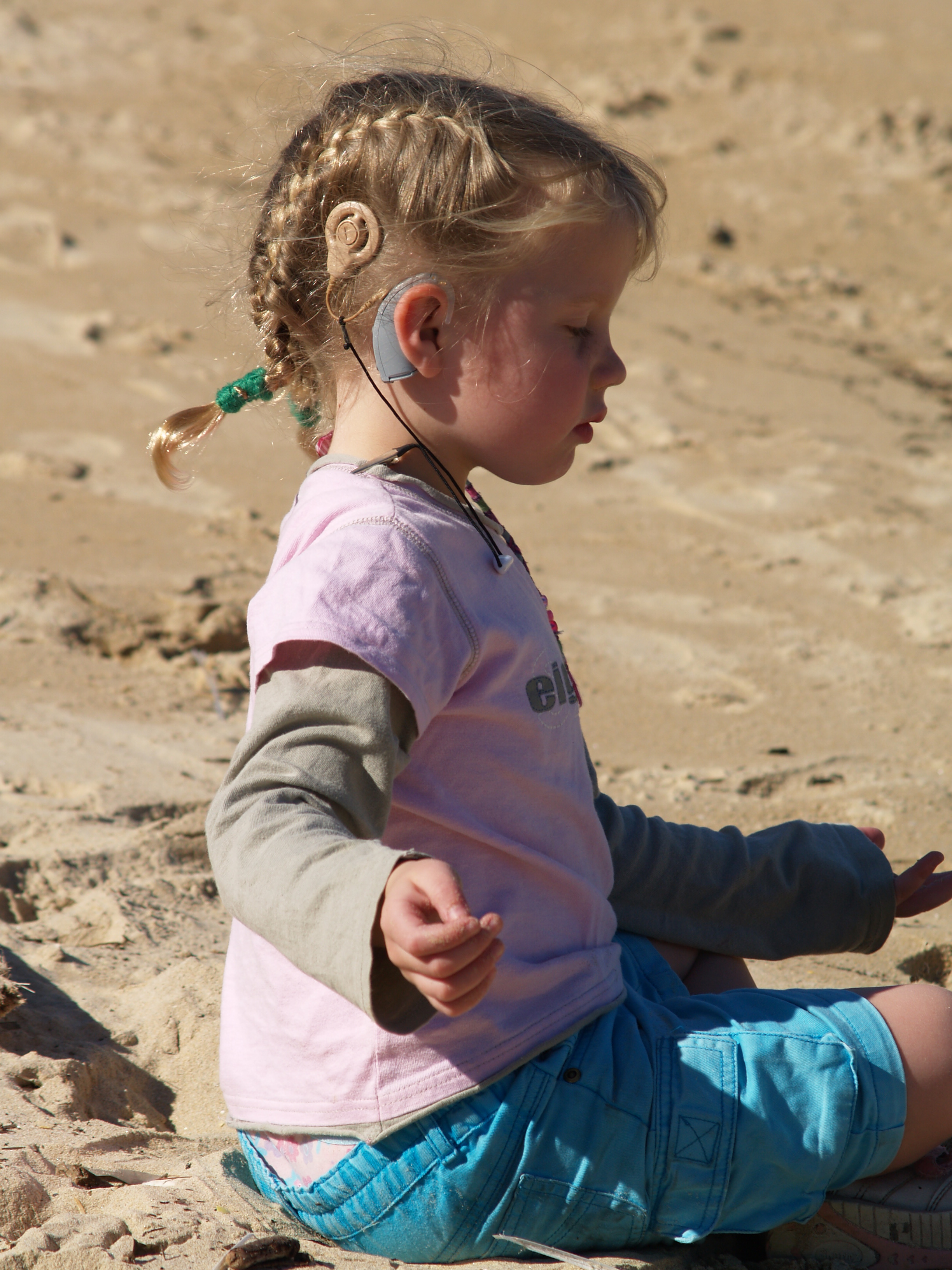 A young child wearing a cochlear implant